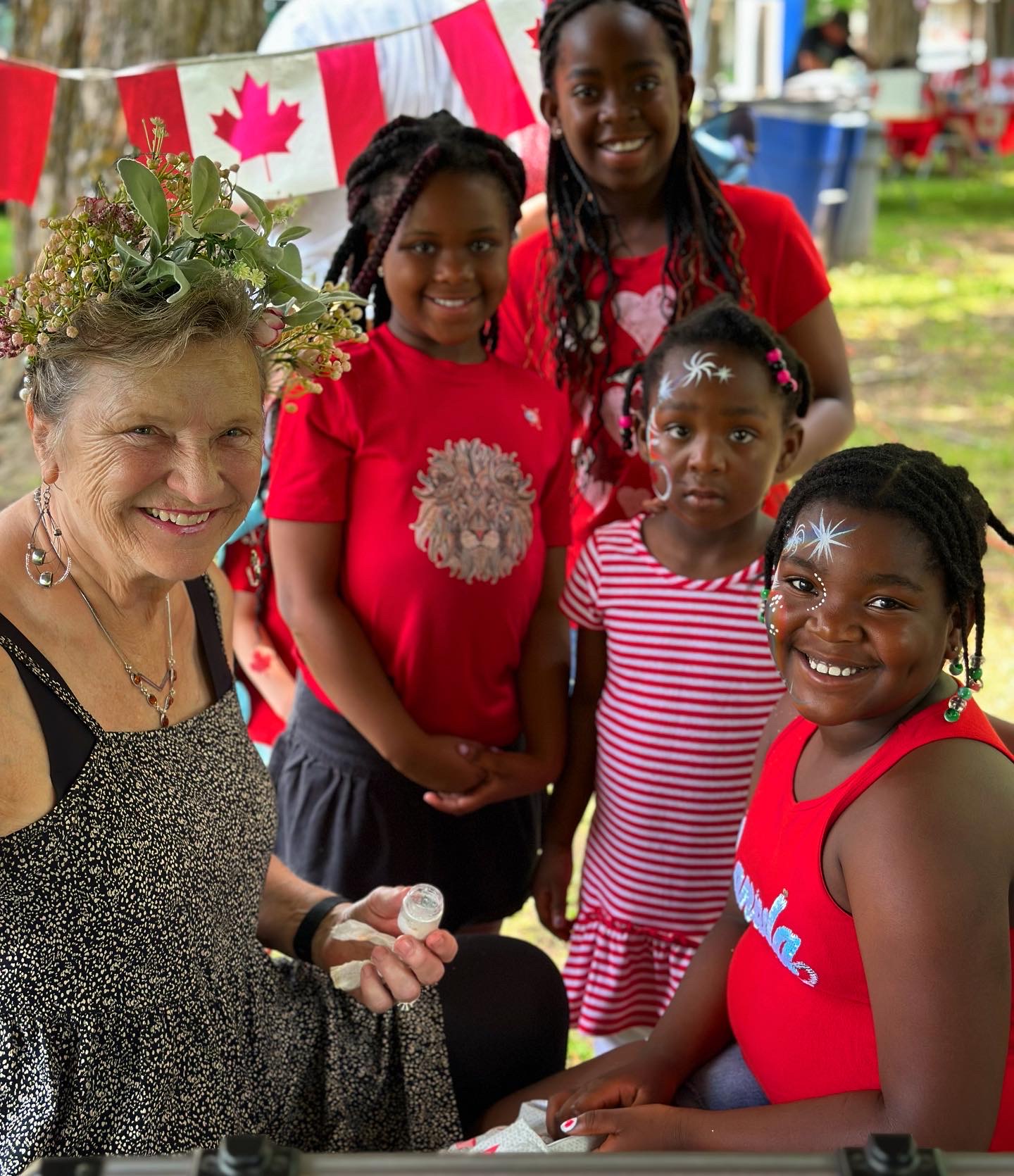 Group of kids getting facepainting on Canada Day